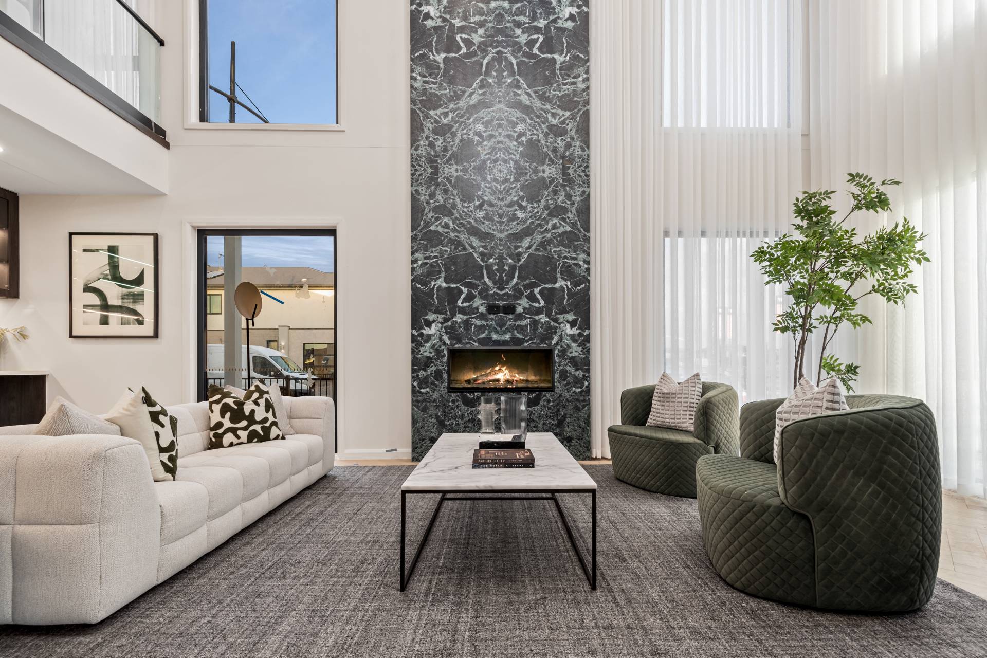 Grand Entry Void with Feature Emerald Marble Fireplace